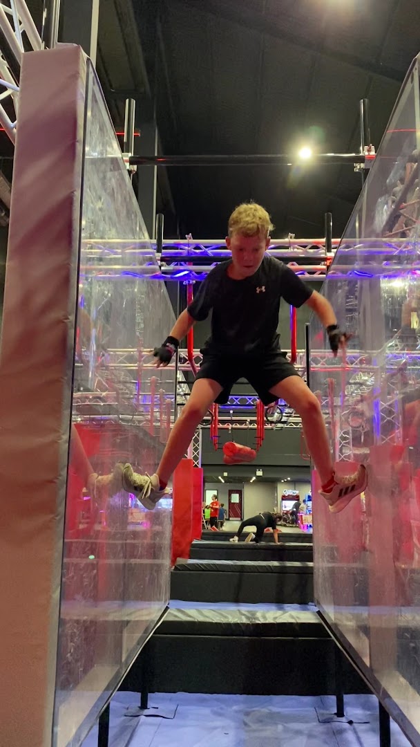 Child navigating climbing walls at Ninja Warrior UK Watford's activity venue