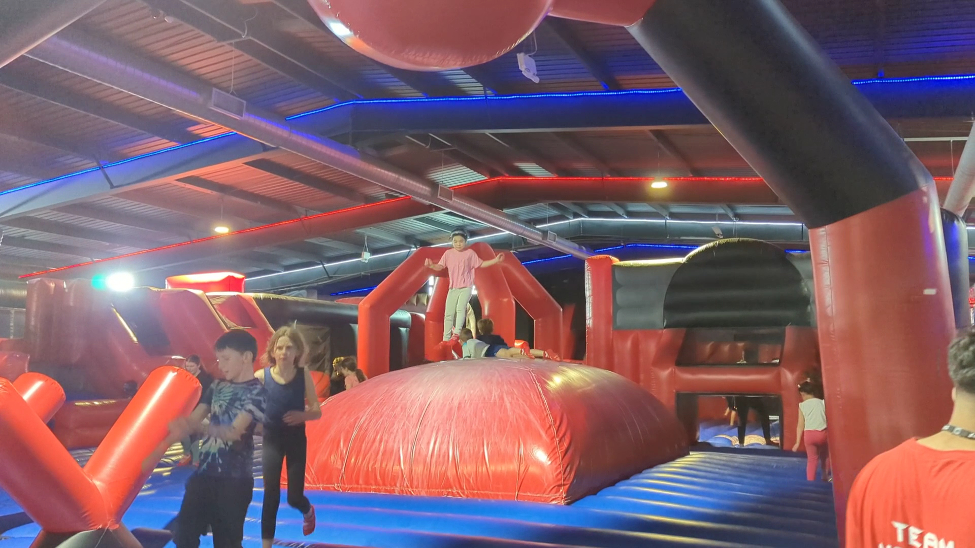 Children enjoying inflatable obstacle courses at Ninja Warrior UK Watford