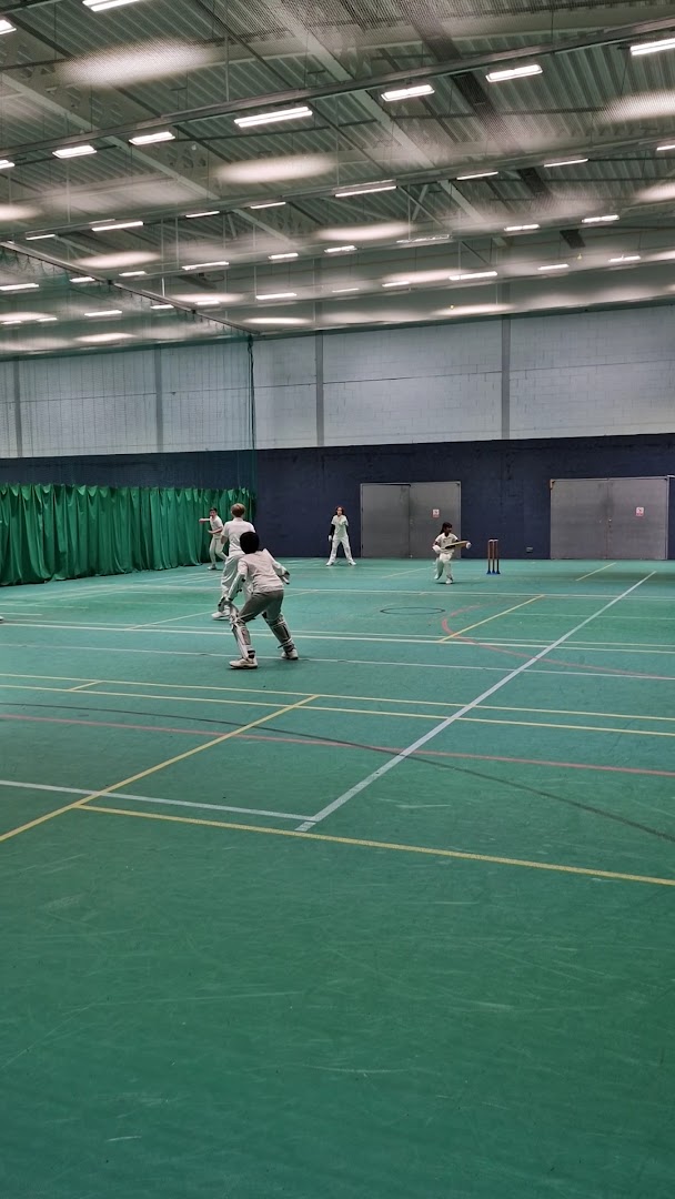 Indoor cricket practice at Peter May Sports Centre with kids playing